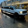 Ford limousine next to hotel